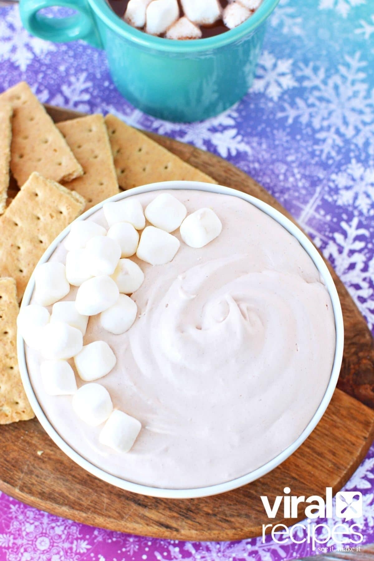 bowl of hot cocoa dip with graham crackers on the side.