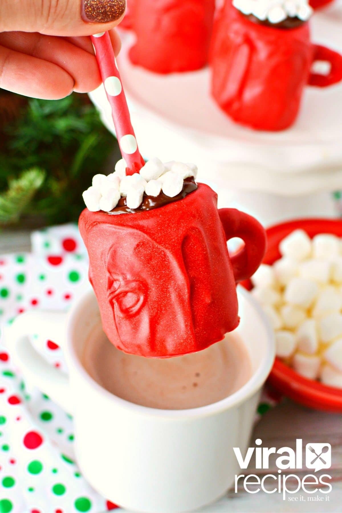 dipping marshmallow into a mini mug.