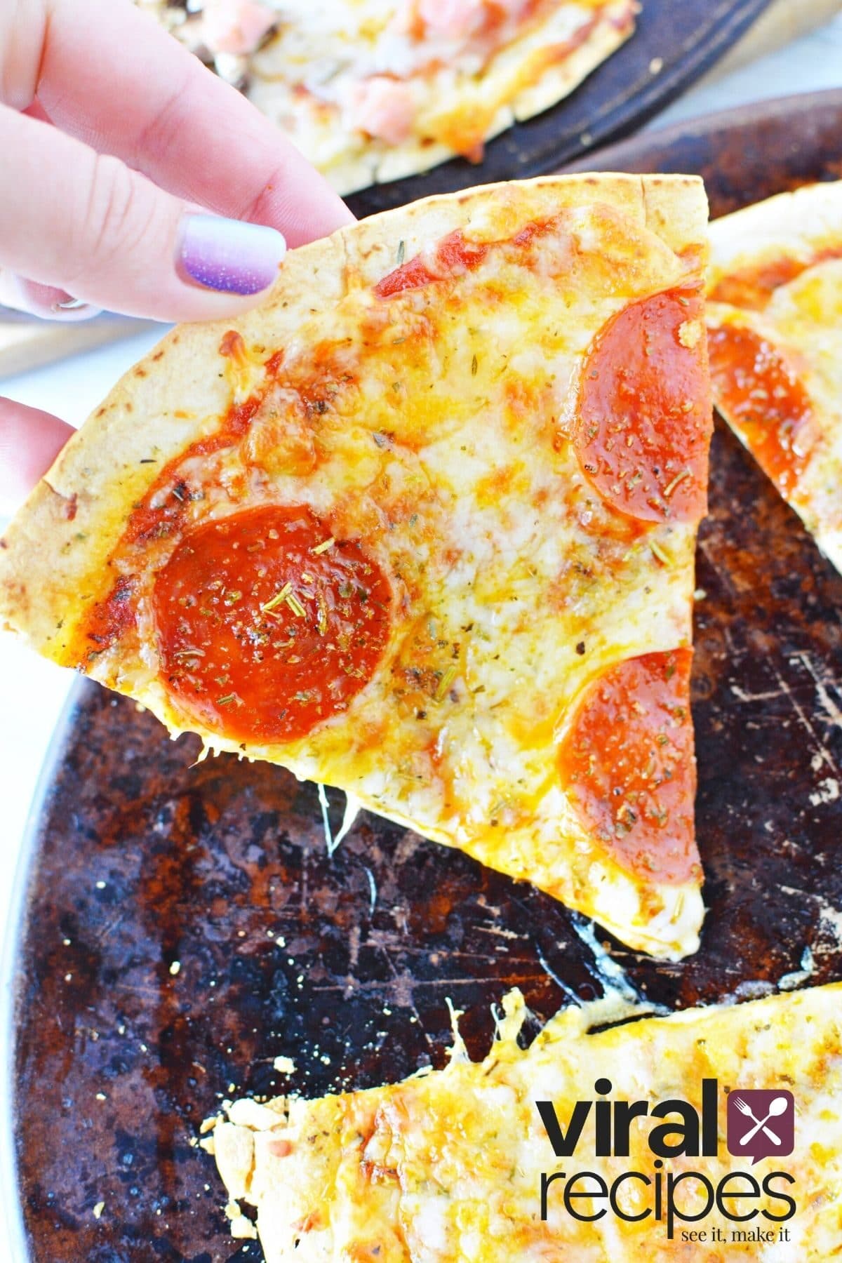 slice of pepperoni pizza being held.