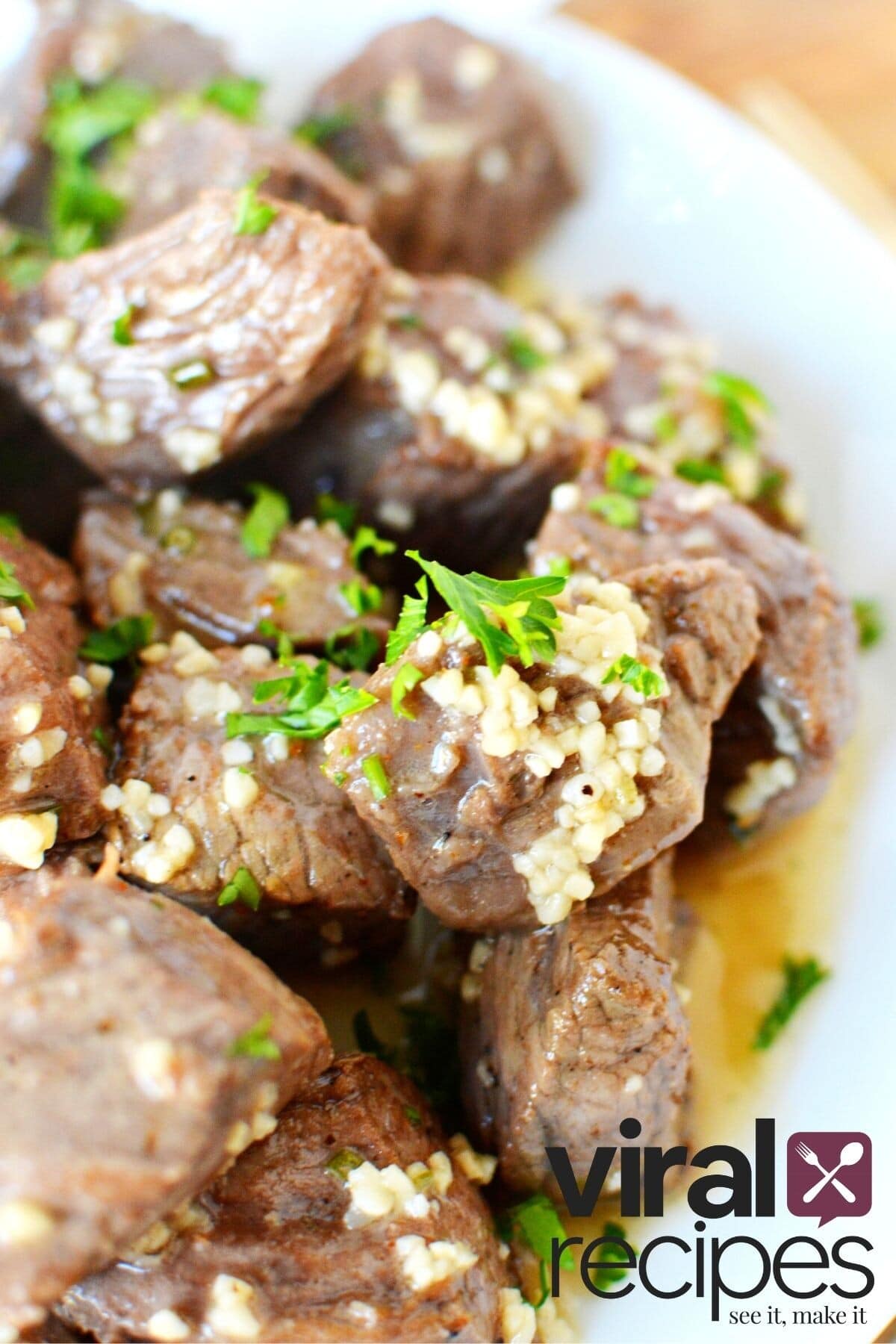 garlic steak bites piled on a plate.