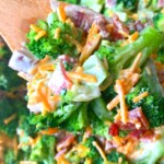 Keto broccoli salad recipe on a wooden spoon.