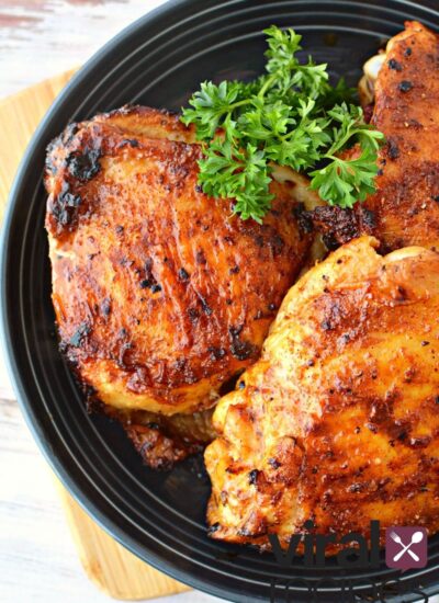 air fryer chicken thighs on a black plate.