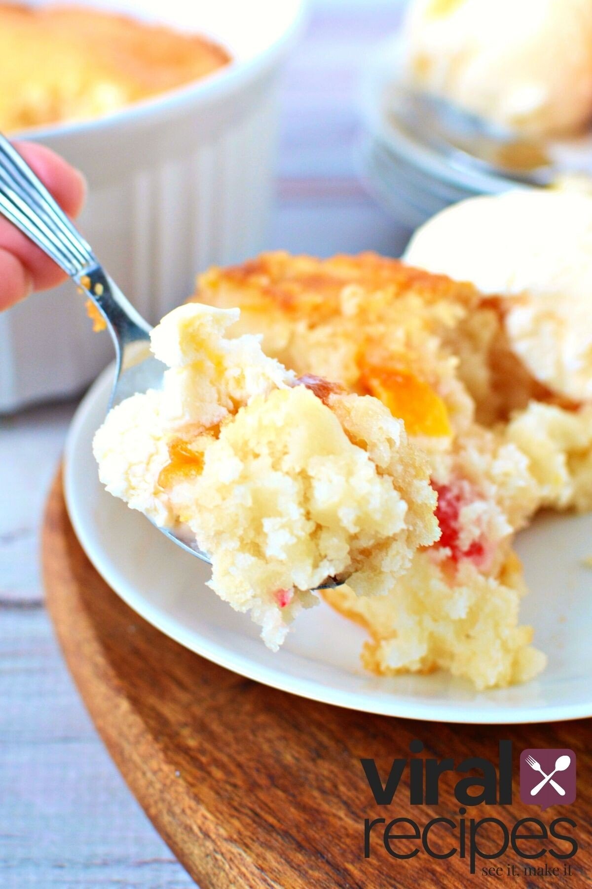 spoonful of fruit cocktail cake on a fork.