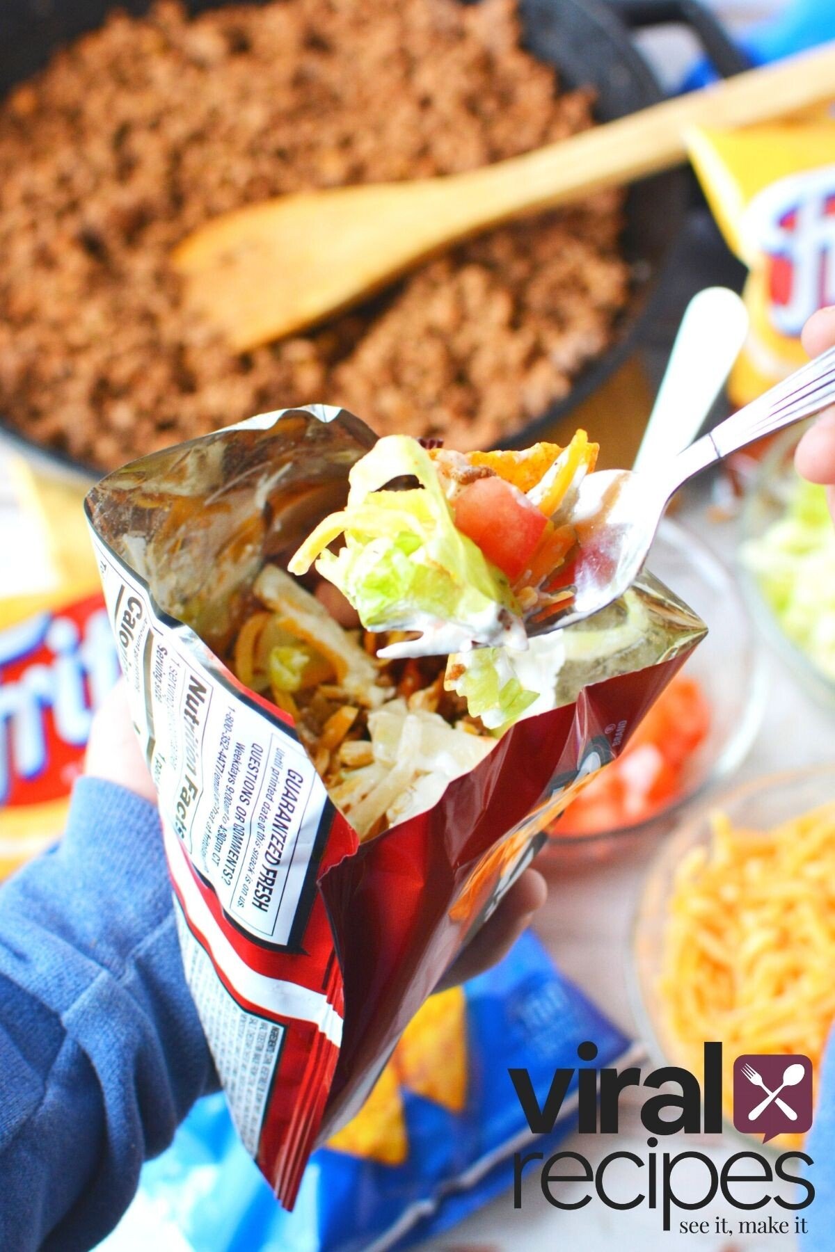 fork full of meat, lettuce and tomatoes.
