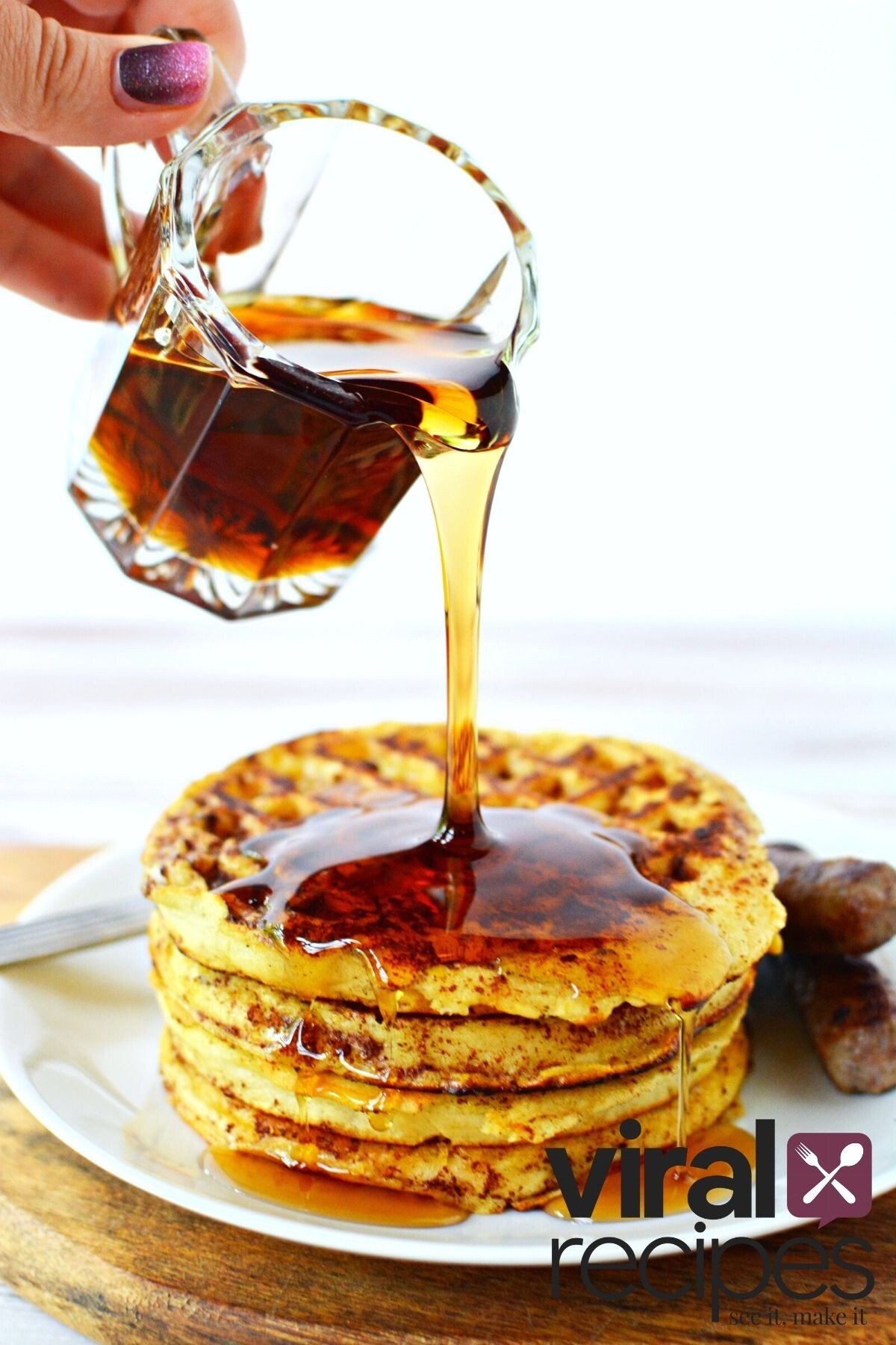 pouring maple syrup on waffles.