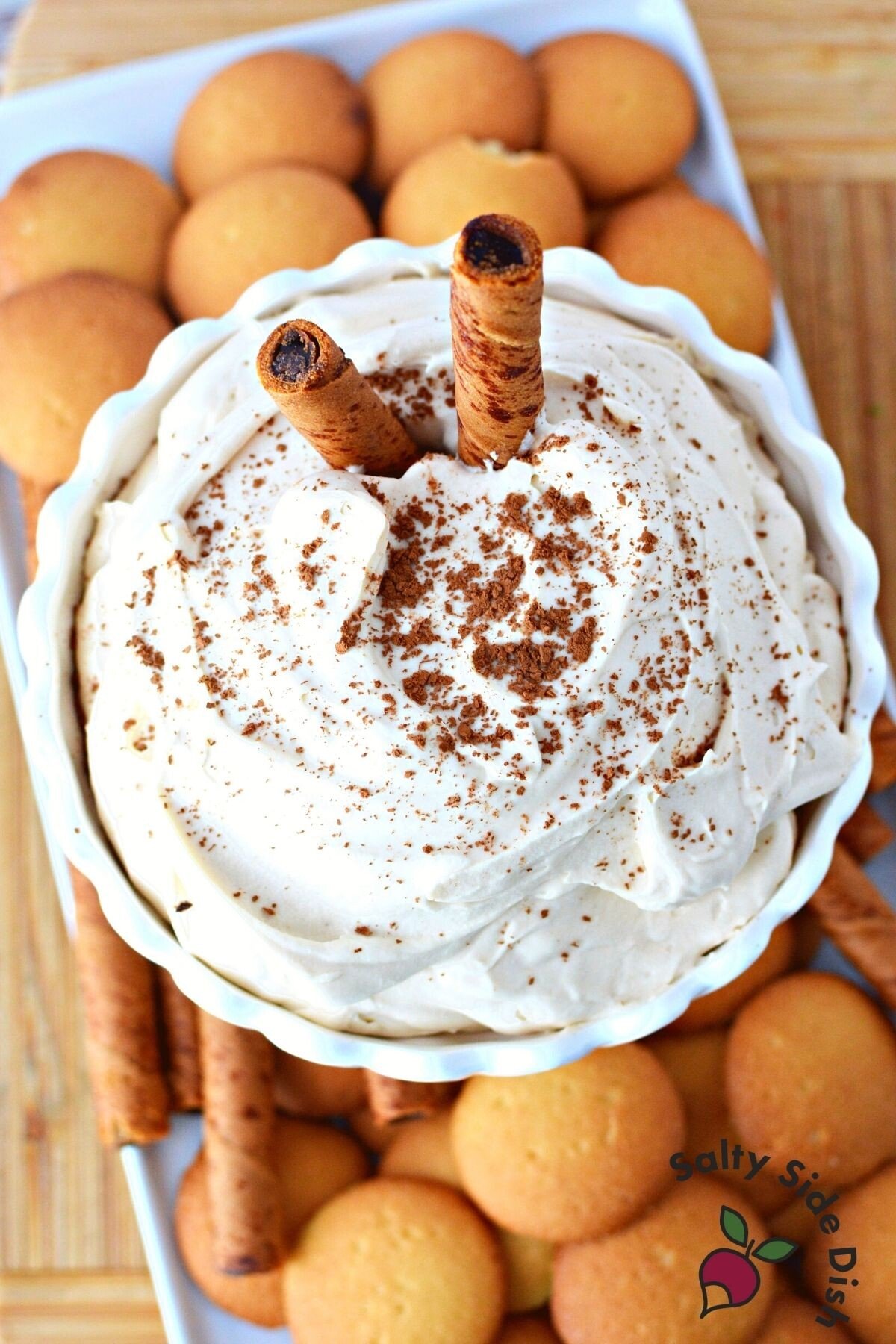 tiramisu dip on a plate surrounded by cookies.