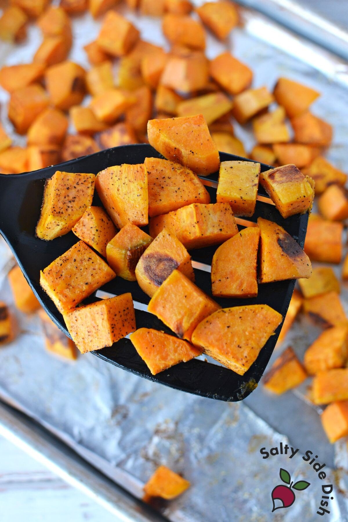 roasted sweet potatoes on a spatula.