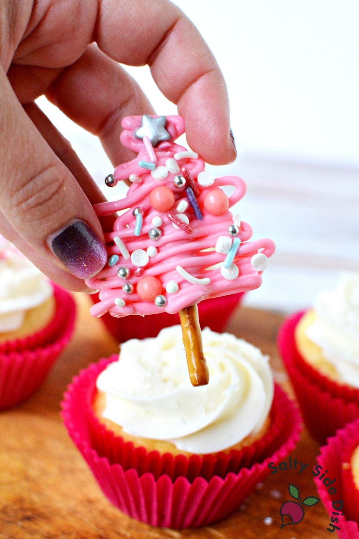 adding pretzel tree to cupcake.