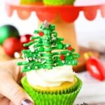 Green shaped pretzel christmas trees made with melting chocolate on a pretzel rod.