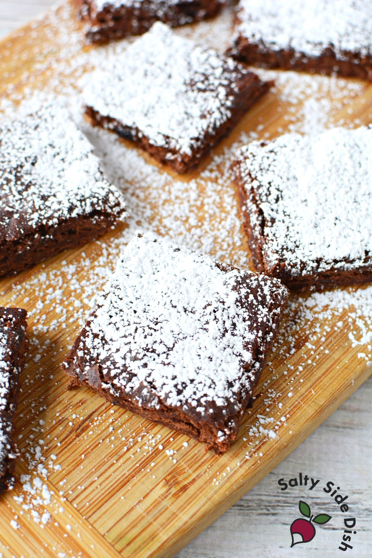 pile of brownies on a cutting board.
