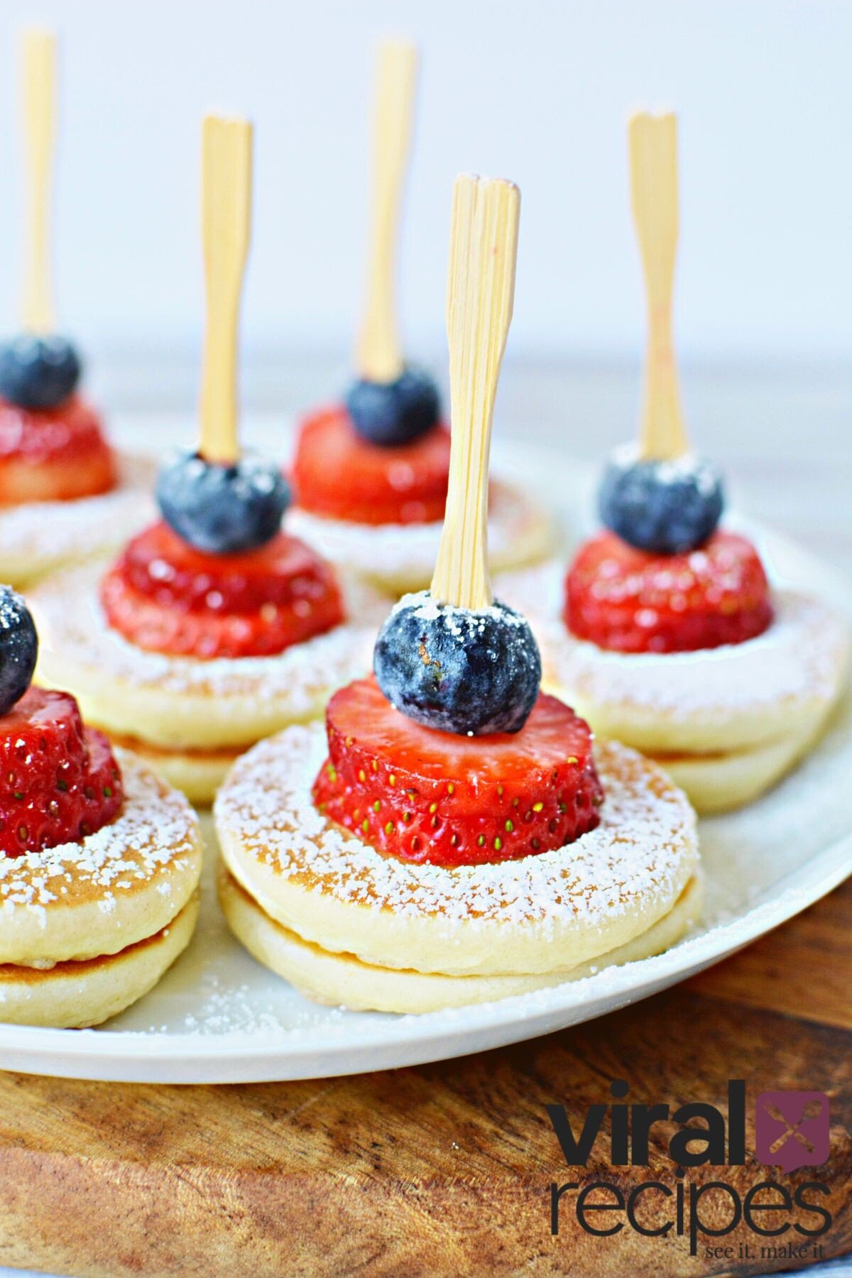 mini pancakes with strawberries and blueberries.