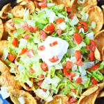 toppings piled high for taco tuesday in a cast iron pan.