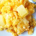 best pineapple casserole dish on a white plate with fork.