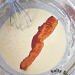 bacon laying in bowl of batter.