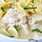 white bowl with chicken, noodles, and homemade gravy.