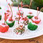 fully decorated christmas cherry bombs on a white plate.