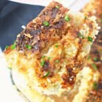 chicken and rice on a spatula being shown close up.
