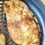 piece of cooked chicken in air crisp basket.