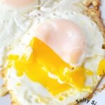 Over-medium eggs on a plate.