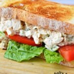 chicken salad sandwich half with lettuce and tomato.