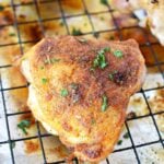 chicken thigh on metal rack.