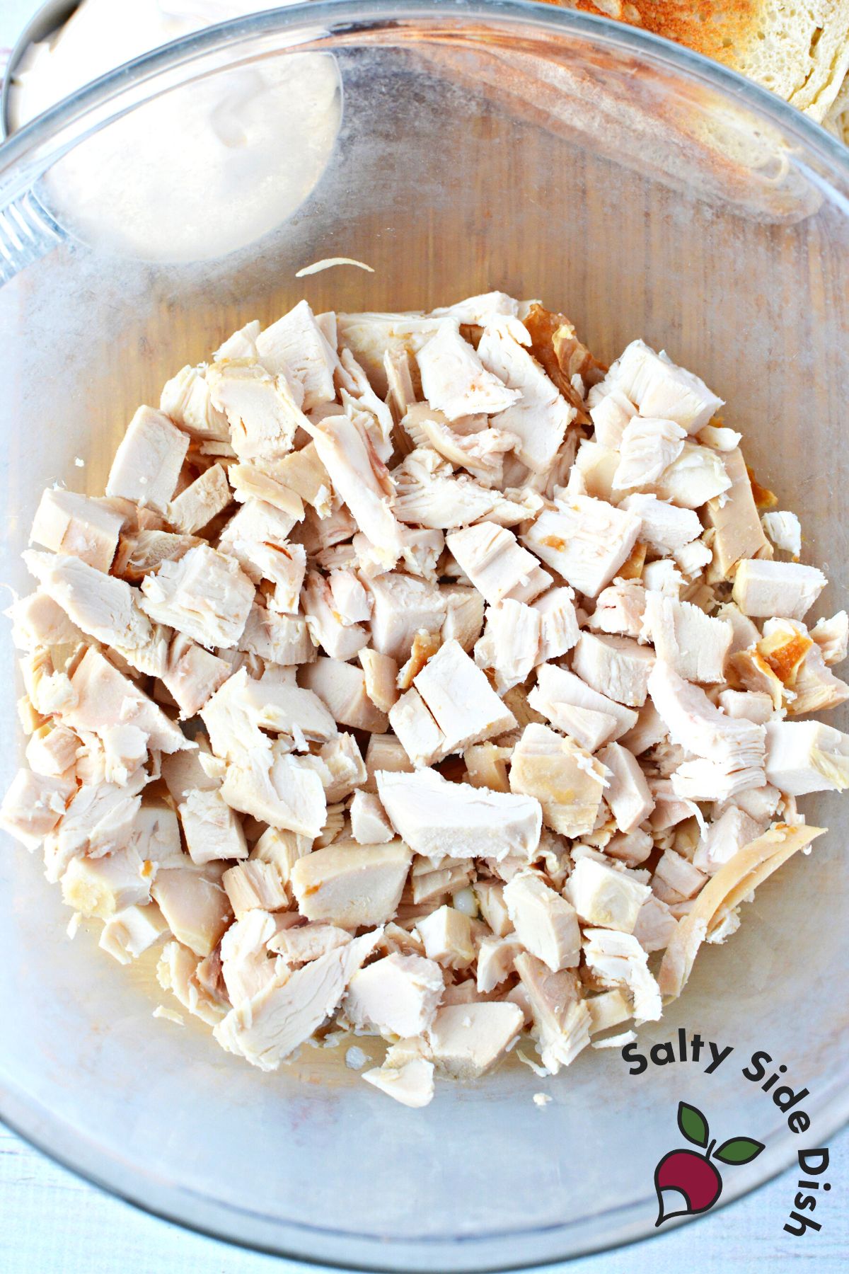 large bowl with 2 cups of chopped and cooked chicken.
