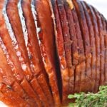 homemade brown sugar ham on a white plate.