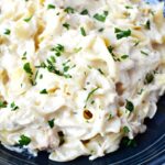 slow cooker chicken made with cream of chicken soup and cream cheese piled on a plate.