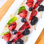 lined skewers with berries and balsamic glaze.