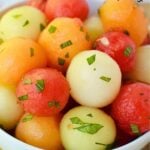 melon ball fruit salad recipe in a white bowl.