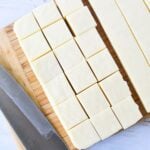 cutting squares of white fudge.