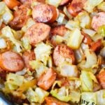 sausage and cabbage in a skillet.