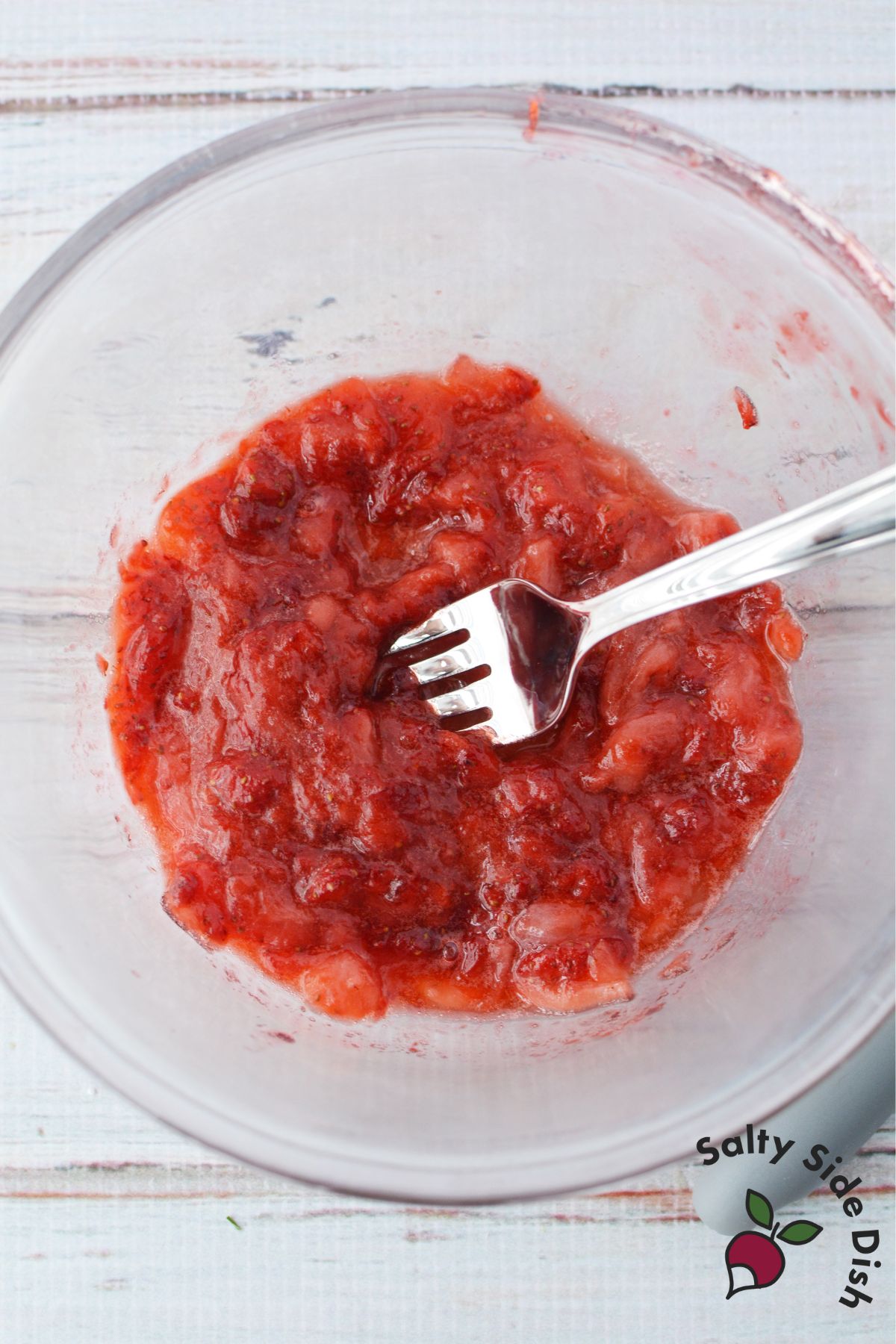 mashed strawberries in a bowl.