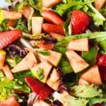 strawberry spinach salad in a bowl.