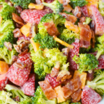 large bowl of broccoli and strawberry salad with bacon.