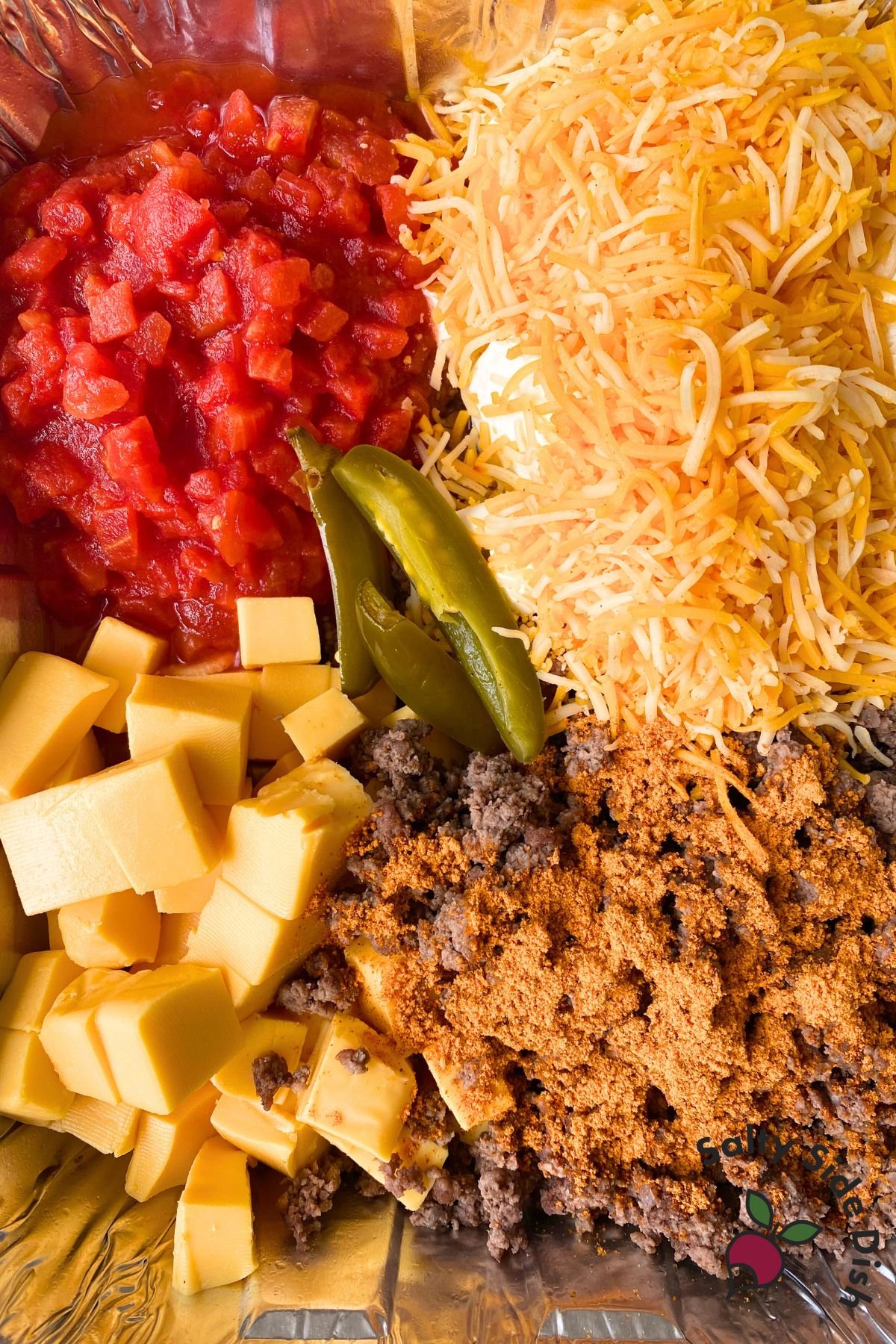 close up of smoked queso ingredients in a disposable pan.