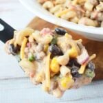 Overhead view of cowboy pasta salad in a white serving bowl.
