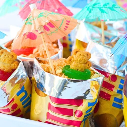 Walking sand cups topped with cookie crumbs, beach bears, and parasols
