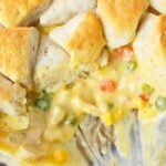 Creamy chicken pot pie filling with vegetables and baked biscuits.