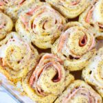 ham and cheese pinwheels in a glass dish.