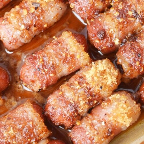 Cooked bacon-wrapped Li’l Smokies with caramelized brown sugar and BBQ rub.