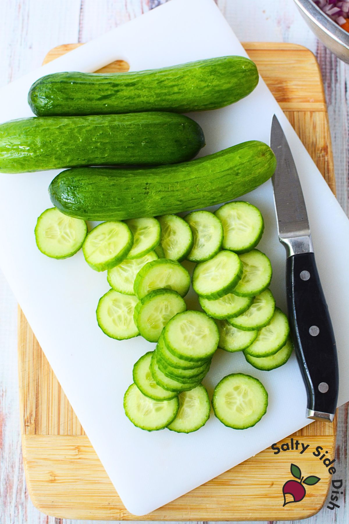 slicing cucumbers on a cutting board.