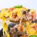 spoonful of tex mex dinner with rice and hamburger.