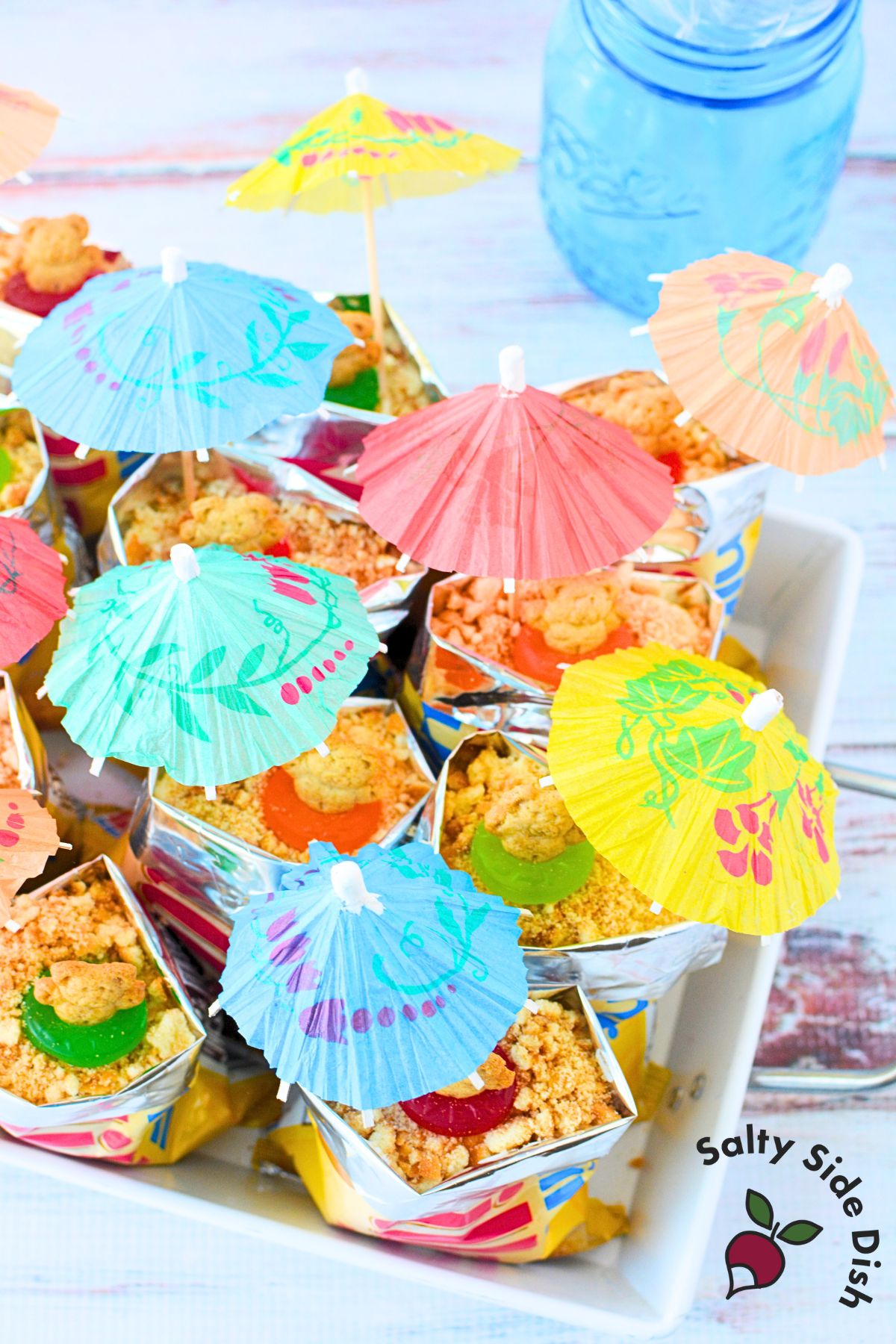 Colorful tray of walking beach pudding bags with mini umbrellas