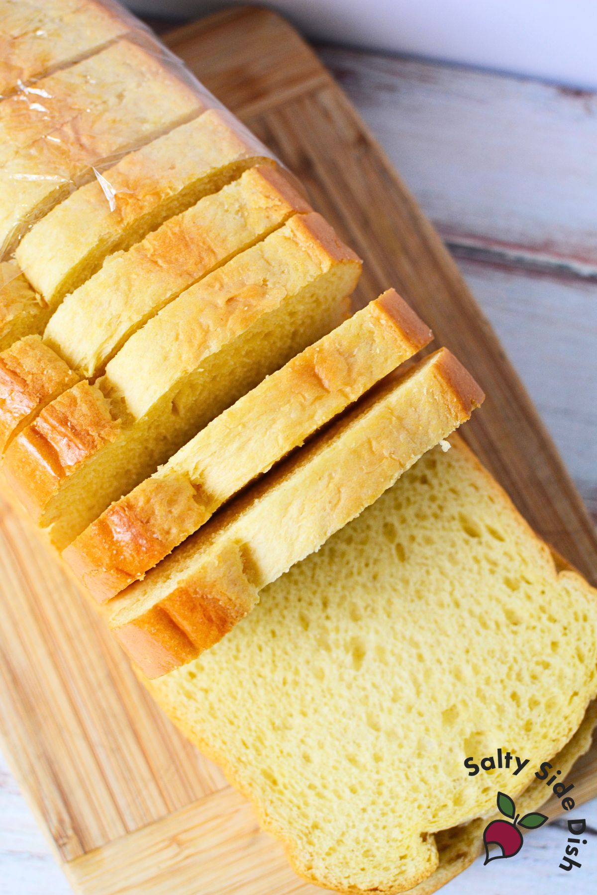 Sliced brioche bread on cutting board, perfect for making brioche French toast with thick, buttery slices.