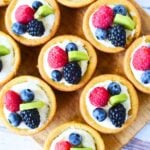 cheese cake cookie cups ready to serve with fresh fruit on top.