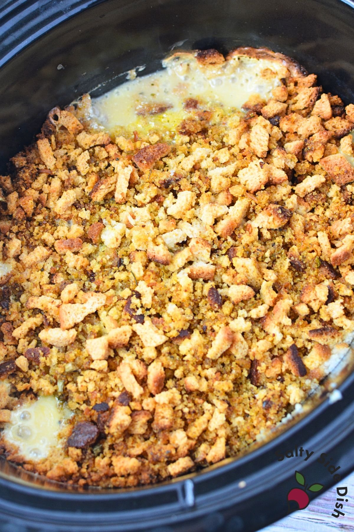 Stuffing mixture cooked on top of creamy chicken in crockpot for slow cooker chicken and stuffing recipe
