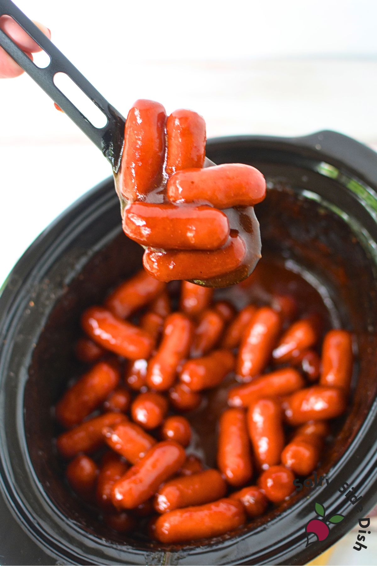 Fully coated little smokies simmering in homemade barbecue sauce