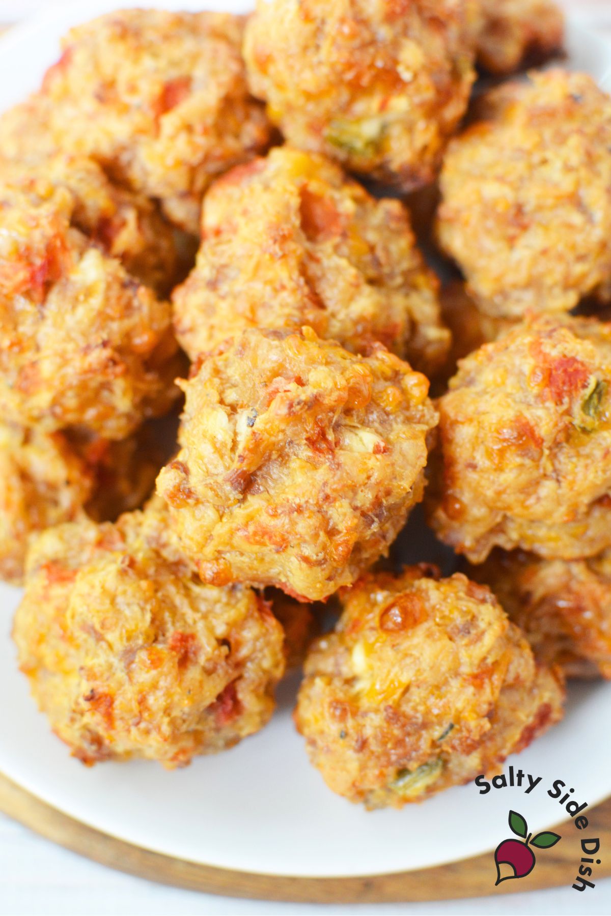 Plated sausage balls piled high, made with cream cheese, Rotel, and sausage