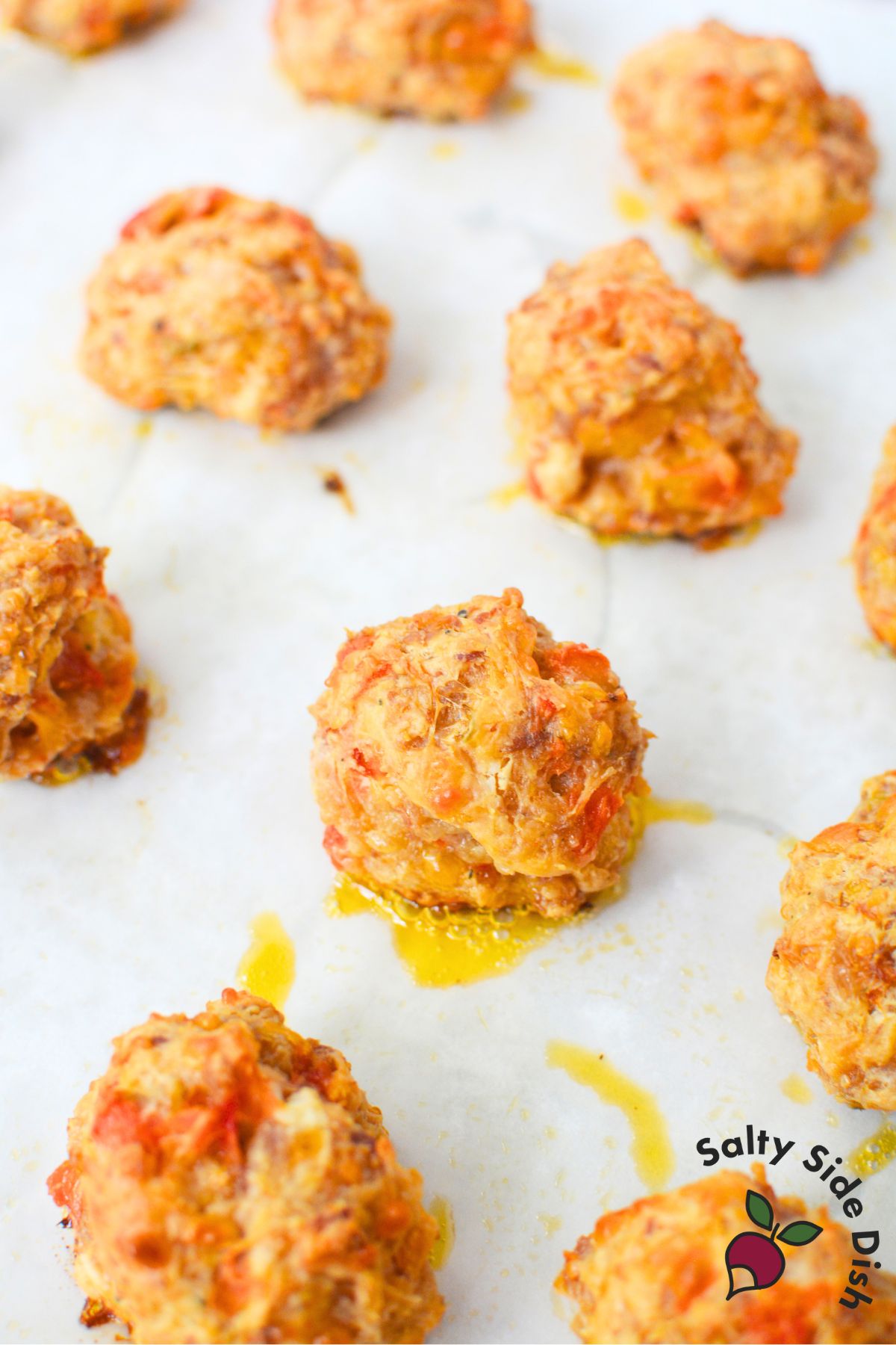 Close-up of golden-brown baked sausage balls with Rotel and cheese